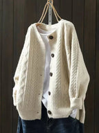 Beige oversized cable-knit button-down cardigan, front